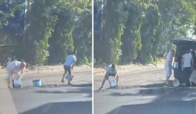 Yola yeni dökülen sıcak asfaltı kovalarla çaldılar